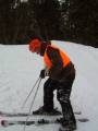Tom fixing his skis back on after skiing into a boulder..!